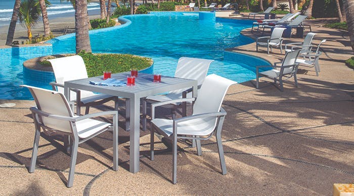 silver chairs with white sling poolside 